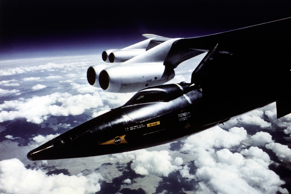 Space History Photo: X-15 Mounted to B-52 Mothership Pylon in Flight